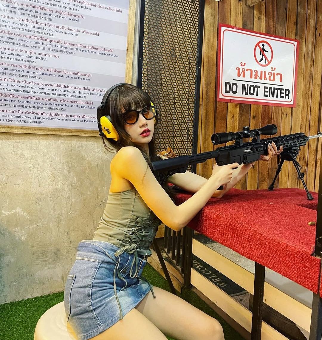 Shooting a rifle at Samui Top Gun range.